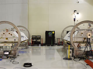  The GRACE-FO satellites, attached to turntable fixtures, at the Astrotech Space Operations processing facility at Vandenberg Air Force Base, California (view 2). 