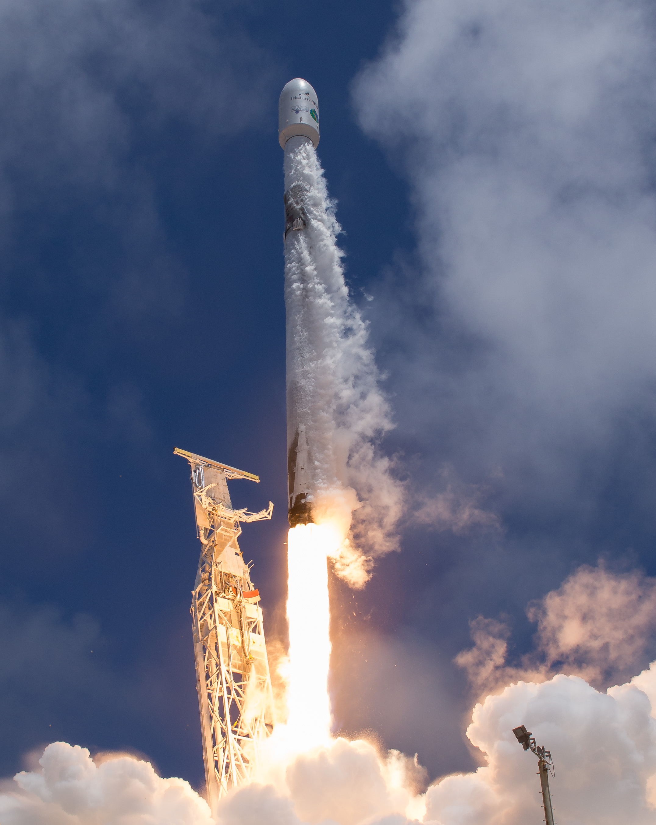 A vertical image of the rocket launching in front of a blue sky.