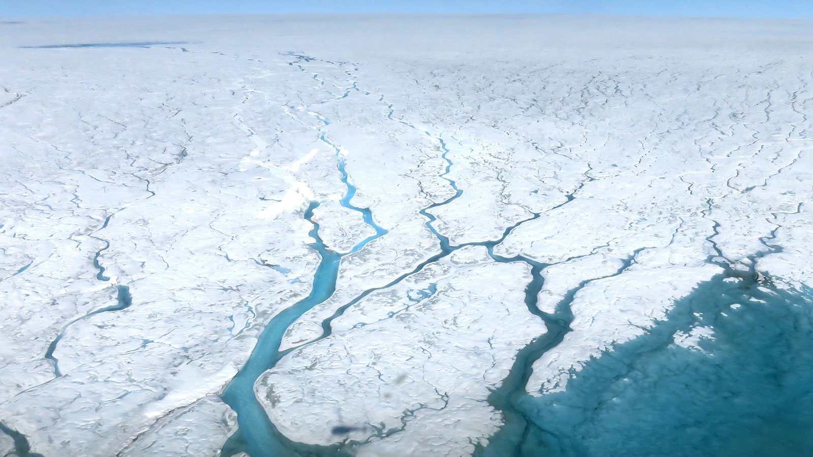 slide 1 - Aerial photograph of meltwater rivers over the Greenland Ice Sheet