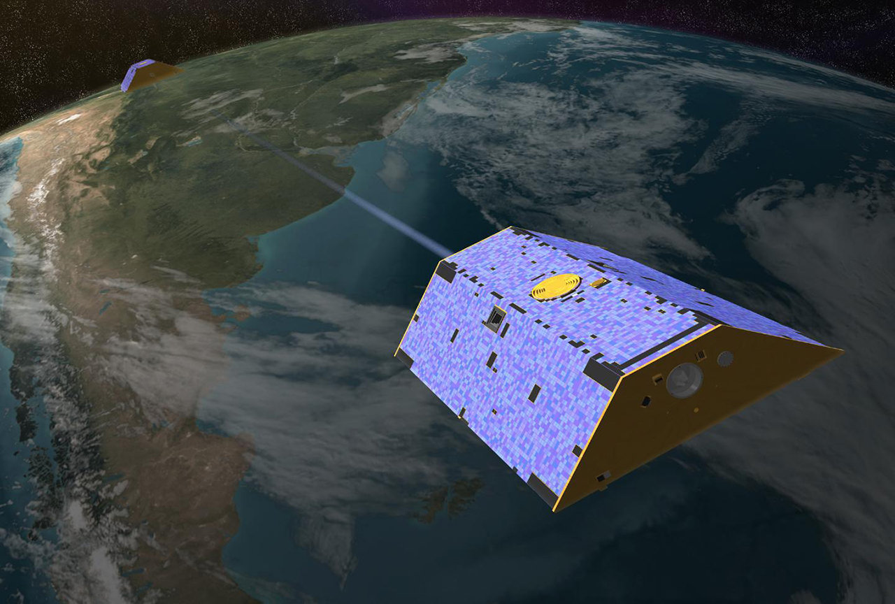 Artist's rendering of the twin Gravity Recovery and Climate Experiment (GRACE) satellites in orbit over Earth.