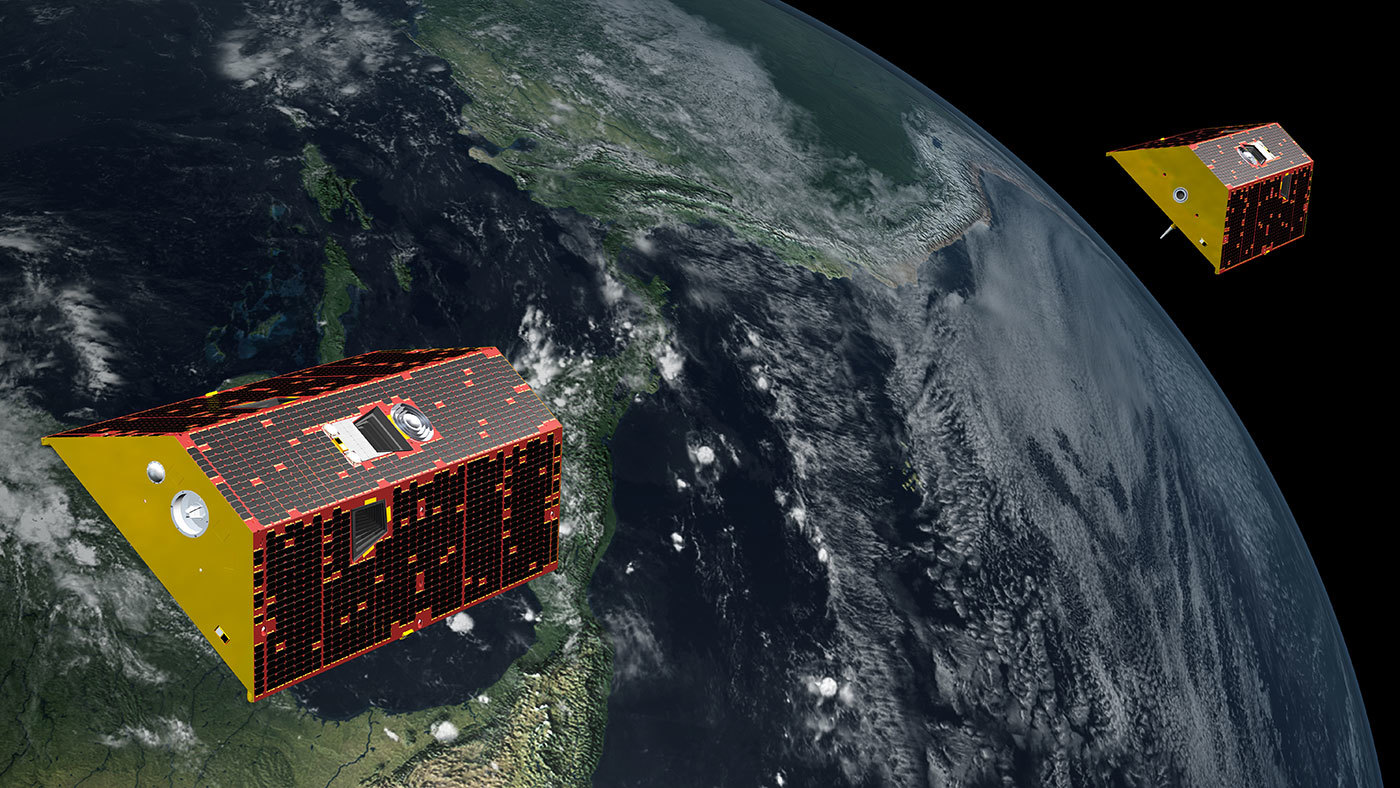 An artist's rendering of the twin GRACE-FO satellites in orbit over Earth.